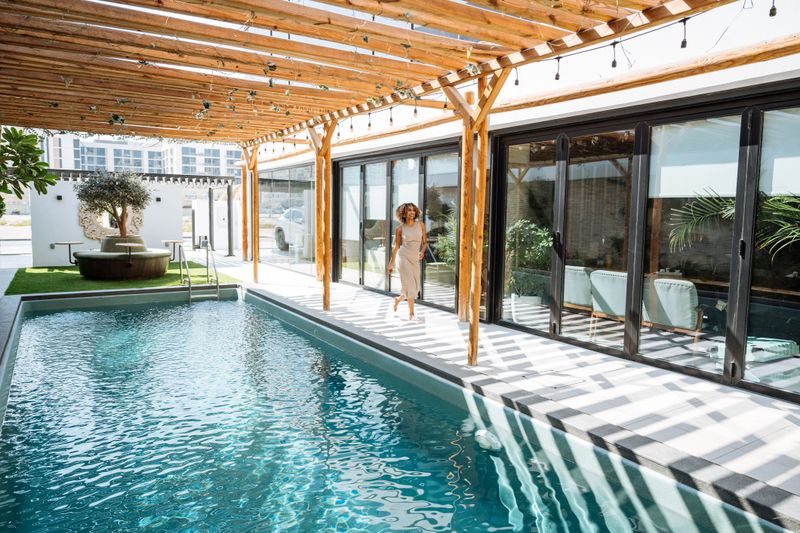One young woman enjoying holiday at luxury villa with swimming pool