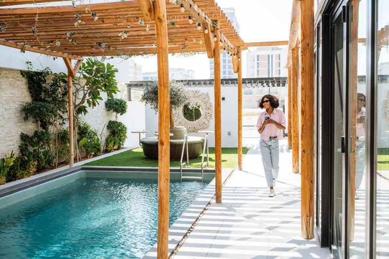 One young woman enjoying holiday at luxury villa with swimming pool