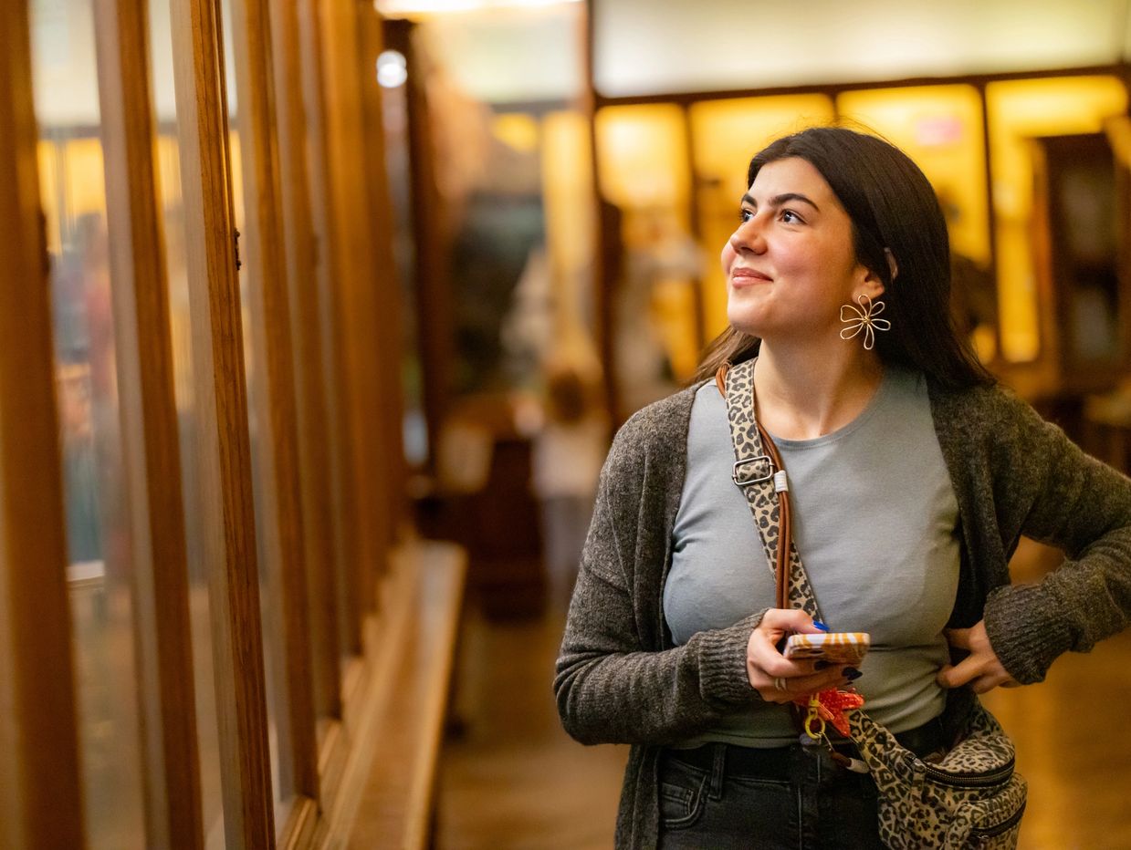 Woman looking at an exhibit in a museum.