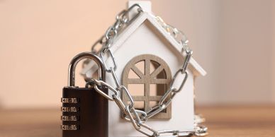Model house secured with chain and lock.