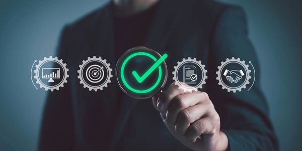 man fingers points at  spinning gears 