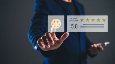 Person in suit giving a five-star customer satisfaction rating.