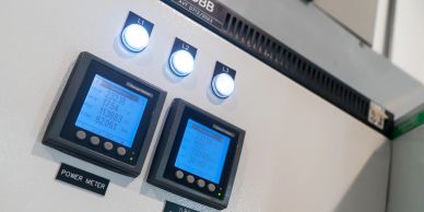 Close-up of power meters with illuminated buttons.