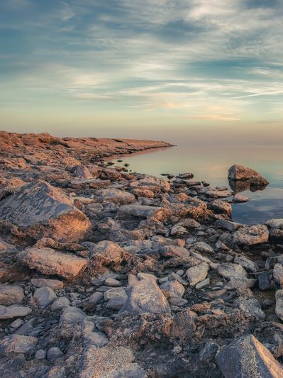 Rocky coastline overlooking calm water, representing hope through anxiety therapy Alberta.