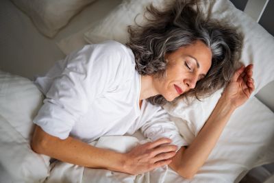 Woman peacefully sleeping in bed.