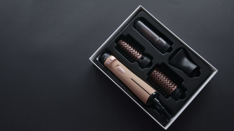 A premium hair dryer and styling brush kit featuring interchangeable heads for versatile looks, presented in an elegant package