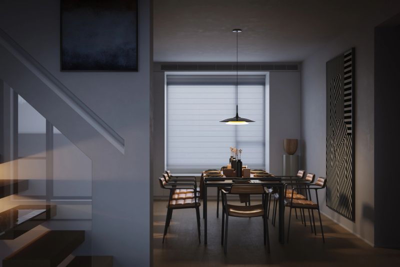 Digitally generated modern dining space at dusk, illuminated by a single pendant lamp over a set table. Subtle window glow, graphic wall art, and wooden chairs create an intimate, contemporary atmosphere for dinner at home.