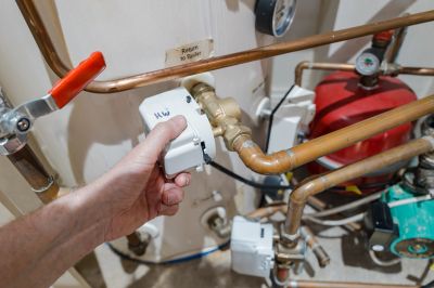 Hand adjusting valve on copper pipes.