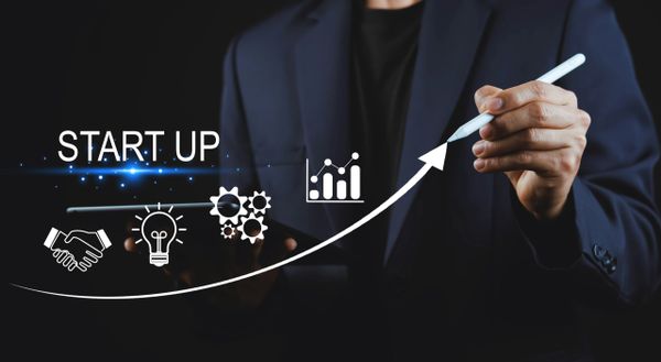 Businessman illustrating startup growth with digital icons and upward arrow.