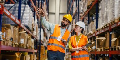 Warehouse workers discussing inventory.
