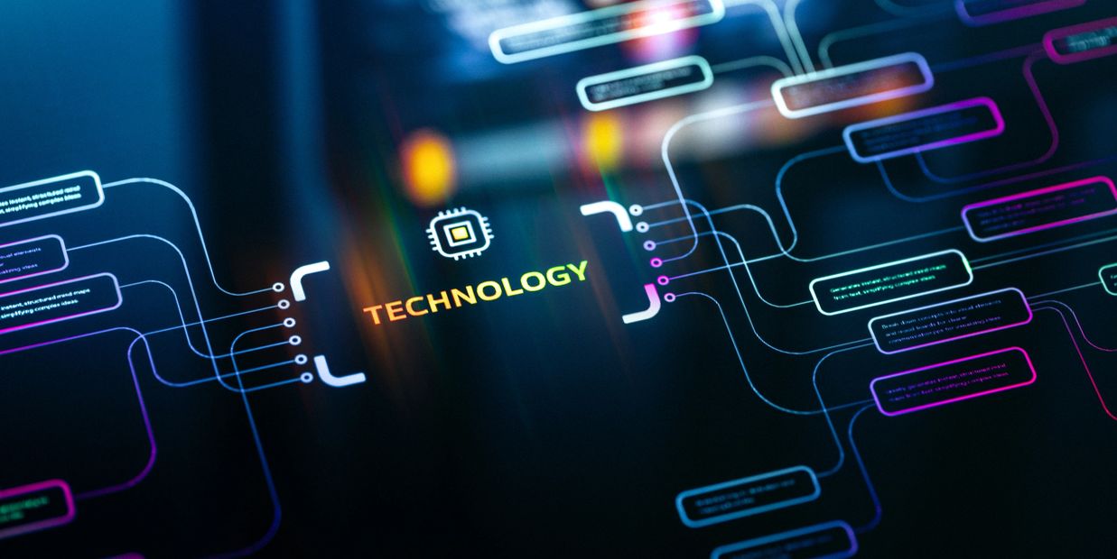 A dual-monitor computer setup with code on one screen and workspace apps on the other.