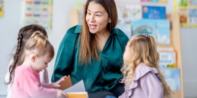 Teacher engaging with young children during a storytime session.