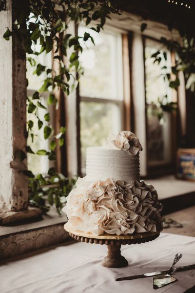 Elegant two-tier cake with ruffled floral design.