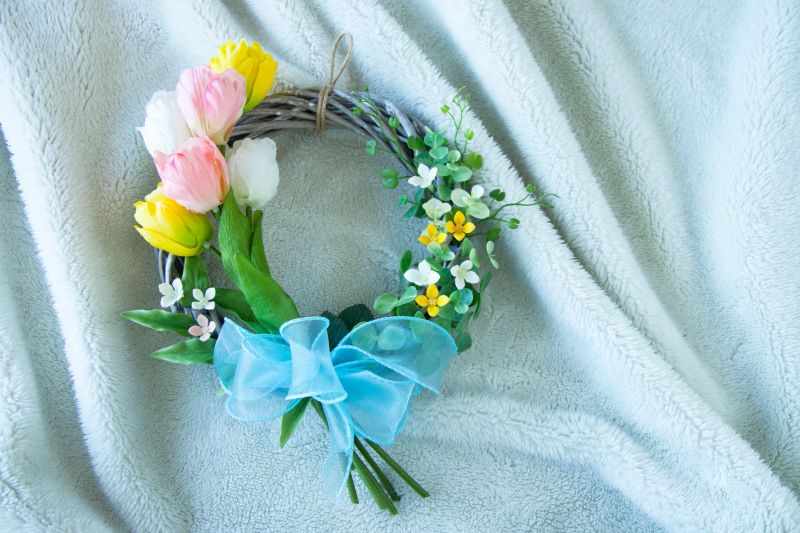 Three Color tulip and bouvardia wreath with white background.