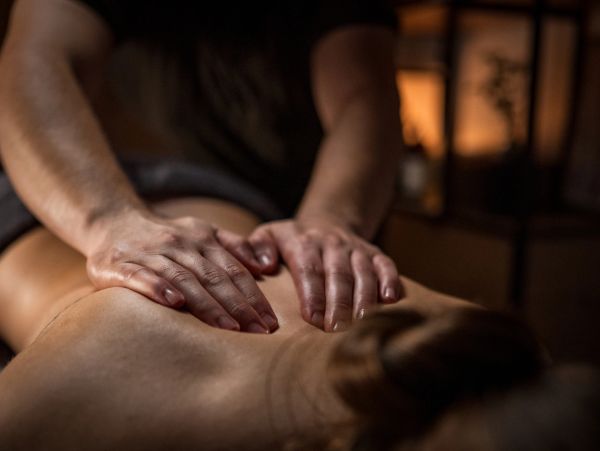 Person receiving a relaxing back massage.