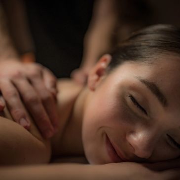 Woman enjoying a relaxing massage with eyes closed.