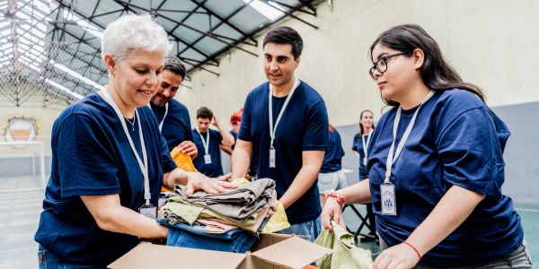 Volunteers sorting clothes at a donation center.