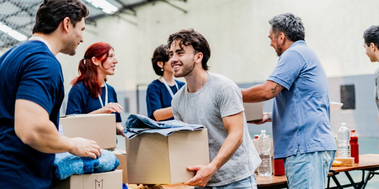 People volunteering and packing boxes with supplies.