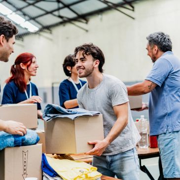 Volunteers packing boxes in a warehouse.