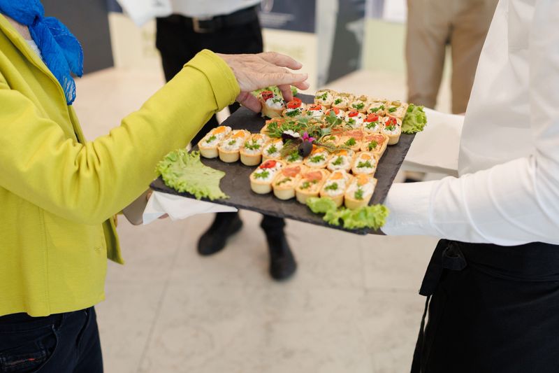Delicious appetizers served on a platter during a formal event in a modern venue