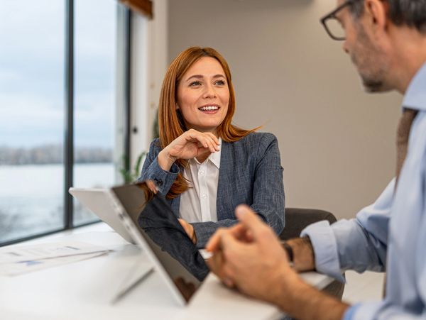 Two professionals engaged in a friendly business meeting.