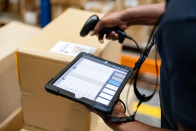 Person scanning a barcode with a handheld device.