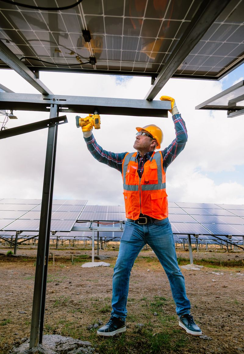 Embark on the journey of renewable energy with this dynamic stock photo, featuring a worker installing a replacement and moving a solar panel at a solar farm. Concurrently, engineers are checking the operation of the system, symbolizing the dedication to alternative energy solutions and the conservation of the world's energy. The photovoltaic module idea further emphasizes innovation for clean energy production. Perfect for conveying the collective effort towards a sustainable future, this photo is ideal for energy-related promotions, environmental publications, and social media content advocating for the global adoption of clean energy. Worker, Installing replacement, Moving, Solar panel, Solar farm, Engineers, Checking operation, Alternative energy, World's energy conservation, Photovoltaic module, Clean energy production, Dedication, Innovation, Stock photo, iStock, Energy-related promotions, Environmental publications, Social media, Sustainable future.