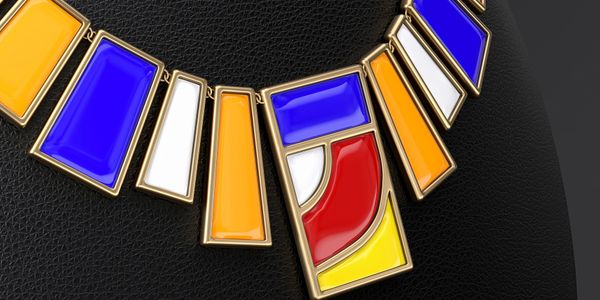 Colorful geometric necklace with gold frames on black leather background.