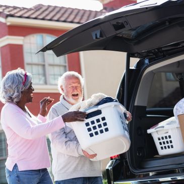 Adults dropping off items at the Cola Kids Consignment Grown-Ups Sale.