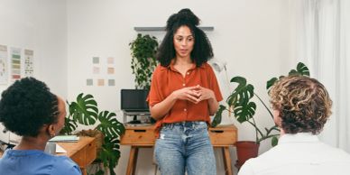 Woman leading a small group discussion indoors.