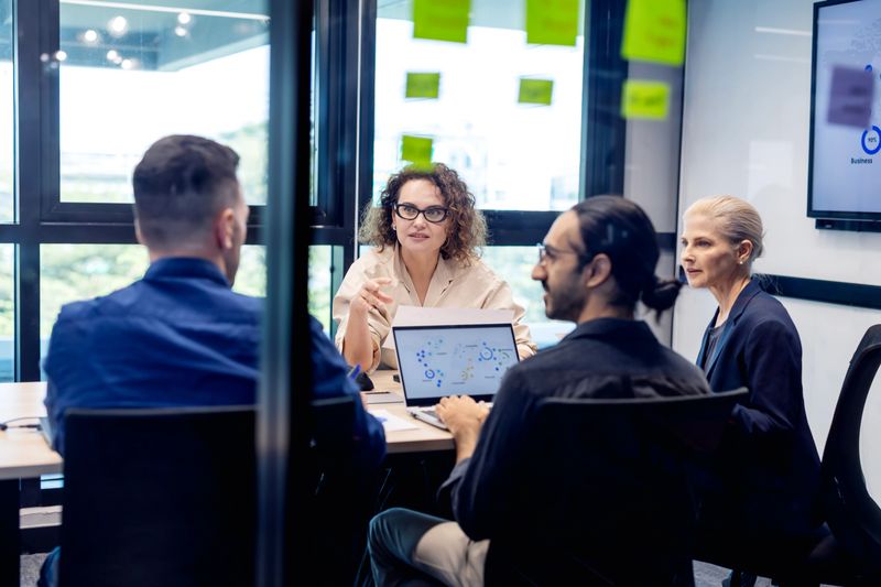 The business development team is analyzing data and sharing insights to refine their offerings. By optimizing products and services during this strategy session, they aim to increase profitability and secure a competitive advantage.