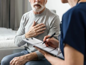 Elderly man consulting a healthcare professional.
