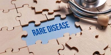 Stethoscope over puzzle revealing 'Rare Disease' text.