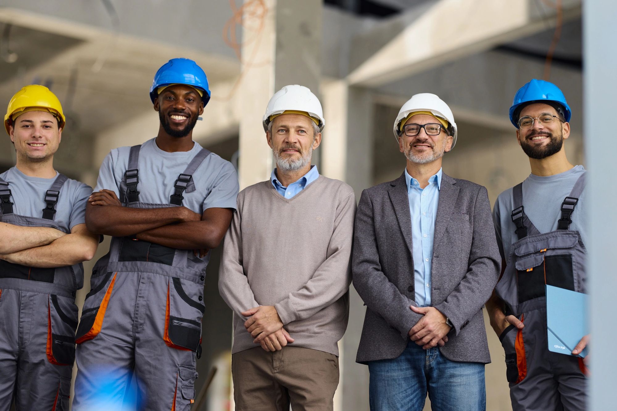 Construction team wearing helmets and safety gear.
