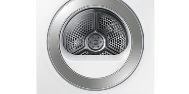 Close-up of an empty stainless steel dryer drum.