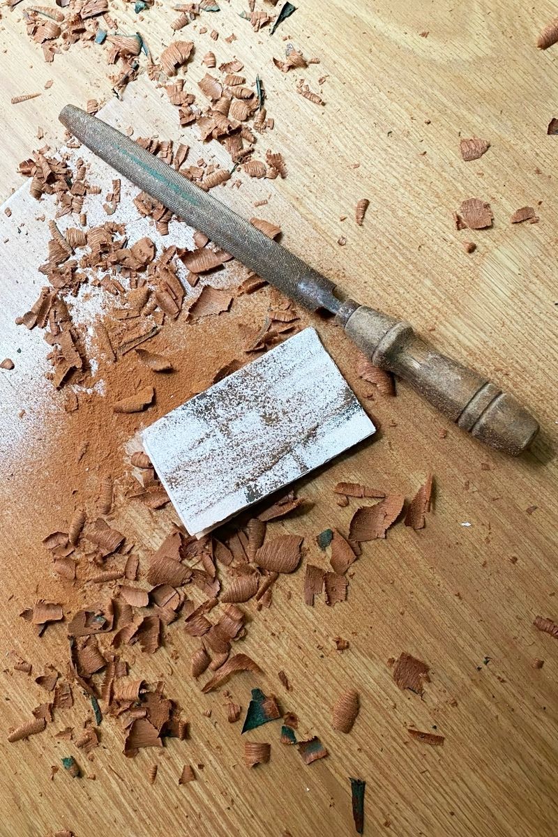 Woodworking tools and shavings on a wooden surface