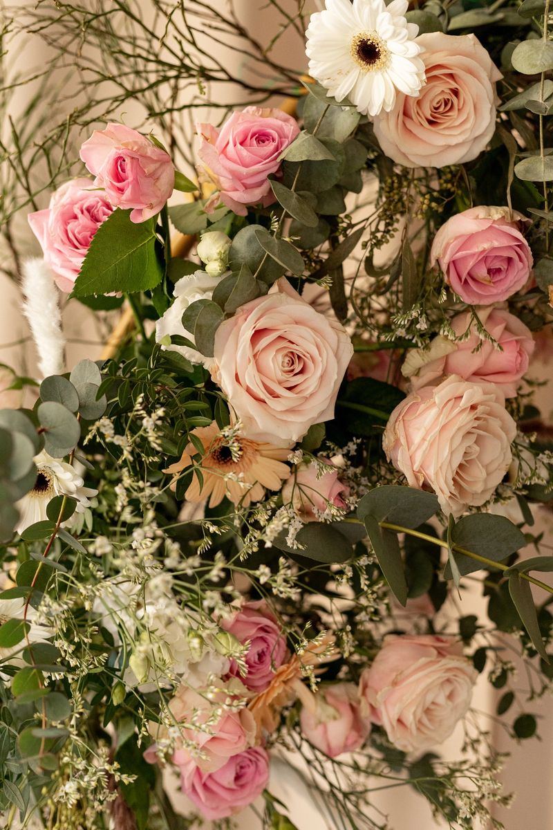 Elegant floral arrangement with pastel roses and eucalyptus in soft natural light