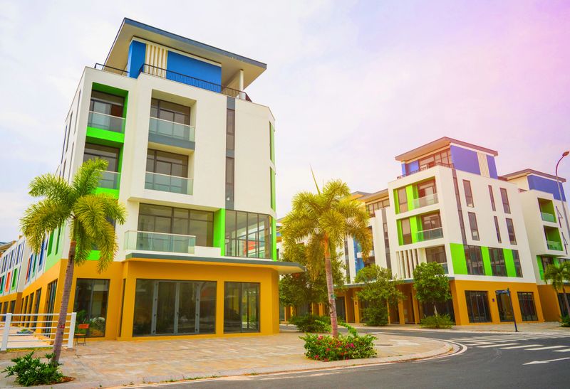 Palm trees on hotel apartments for vacation holiday. Resort street with apartment building with palm trees in tropical. Reidential building with palm trees. Houing project hotel apartment, Phu quoc.