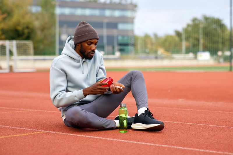 Sportsman preparing supplements during outdoor workout break