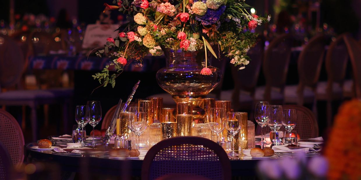 Elegant dinner table centerpiece with flowers and candles.