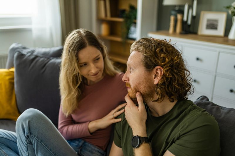 Woman comforting man while having a serious talk in their living room