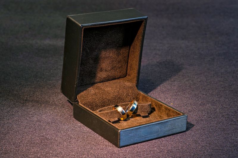 A couple of wedding rings in a black box on a table.