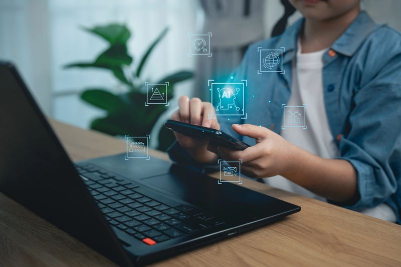 Close-up, Hand girl using magnifying glass with laptop and virtual security shield, concept of cyber safety, data analysis, internet privacy protection, and digital literacy for children
