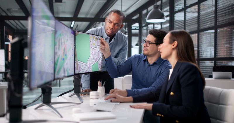 Team Of Diverse Professionals Using GIS To Map Real Estate Projects.