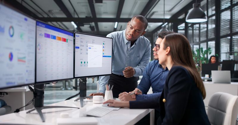 Modern Office Scene With Diverse Payroll Team Successfully Managing Data