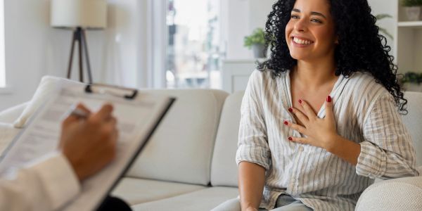 Young woman talking to a therapist in a cozy office.