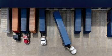 Aerial view of trucks docked at a warehouse.