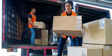 Warehouse workers unloading boxes from a truck.