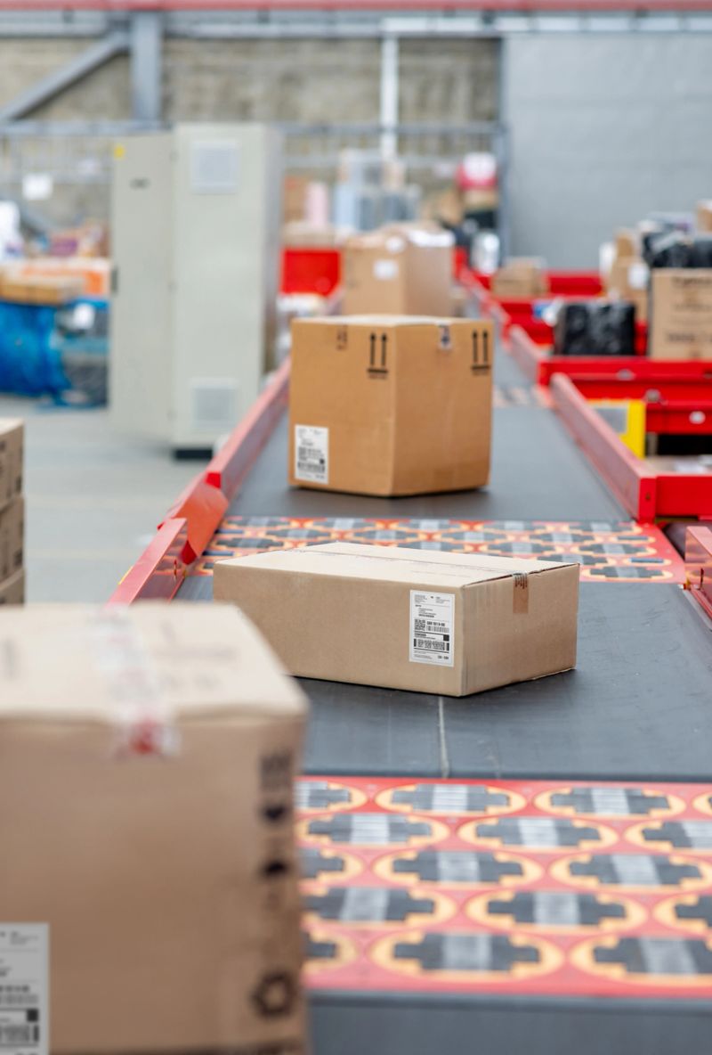 Close-up on packages moving on a conveyor belt at a distribution warehouse