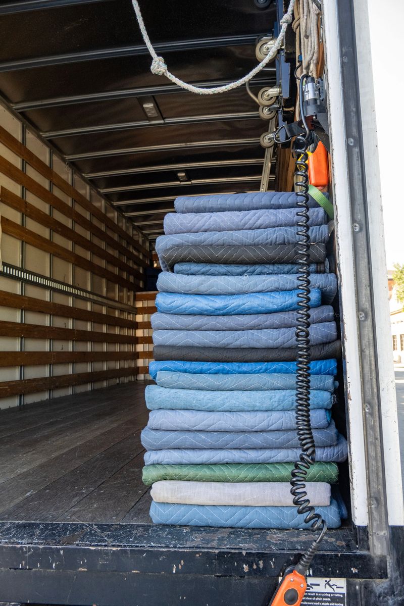 A truck with a few mattress pads neatly folded and stacked